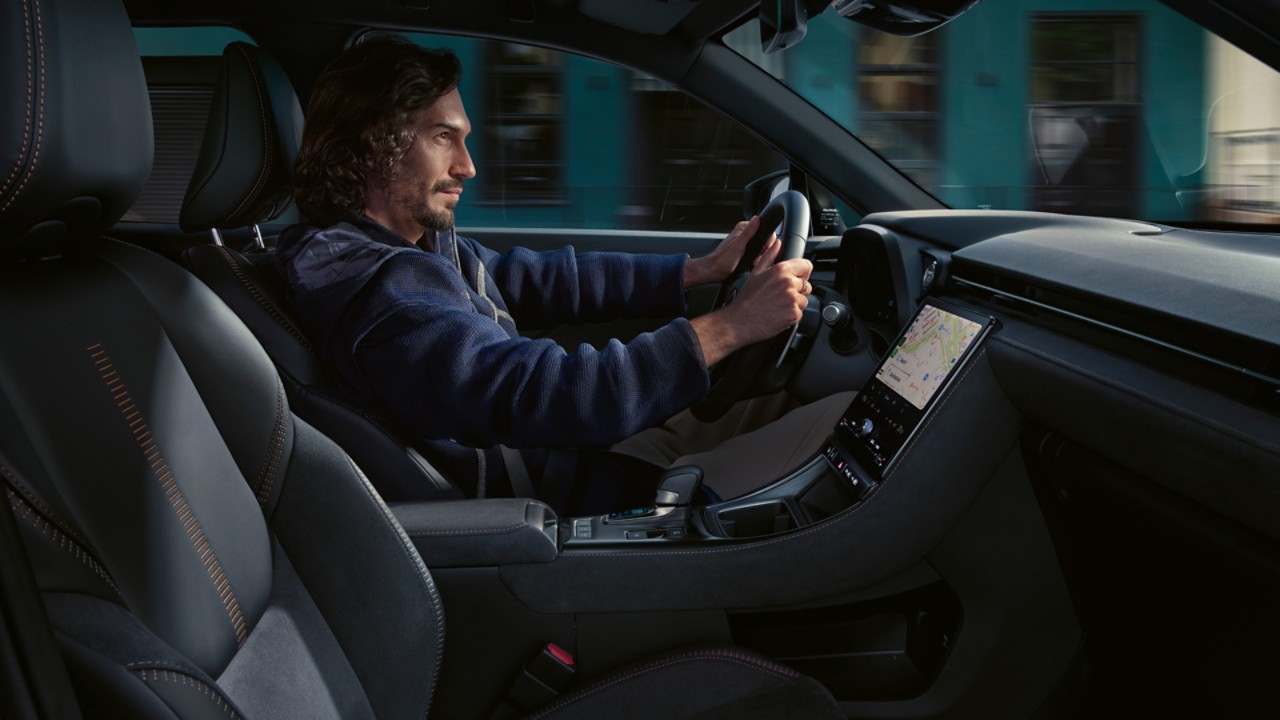 A person driving a Lexus LBX