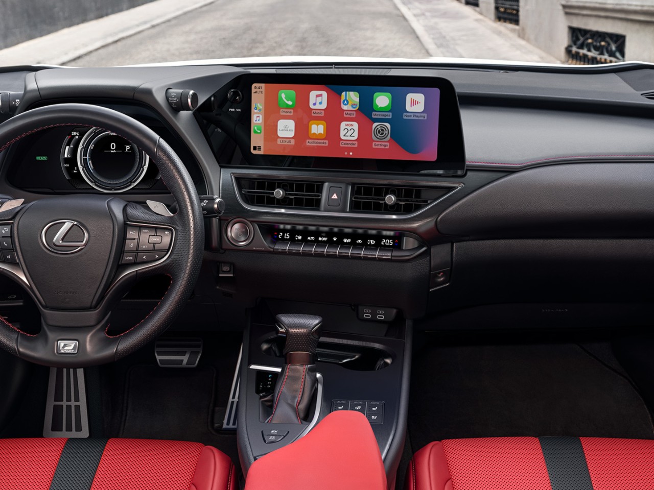 A woman driving a Lexus UX badge 