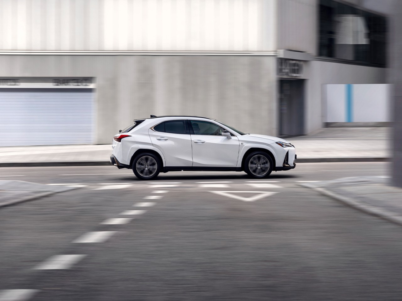 Side view of the Lexus UX driving 