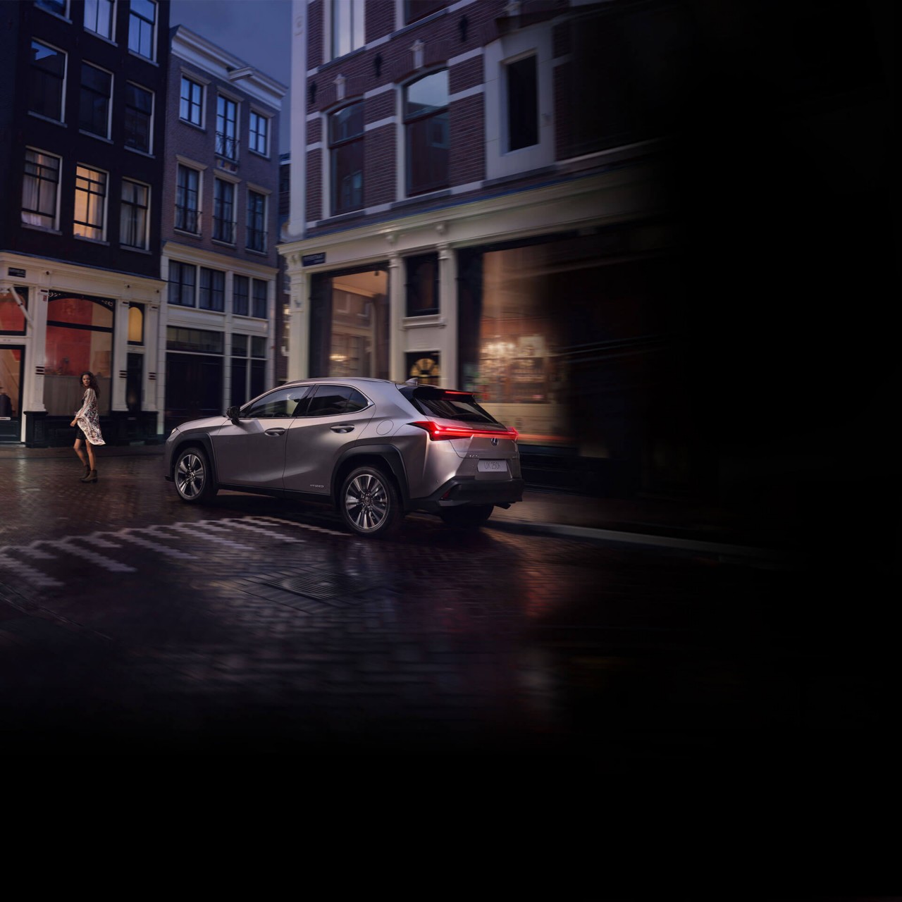 Lexus NX driving in a town location 