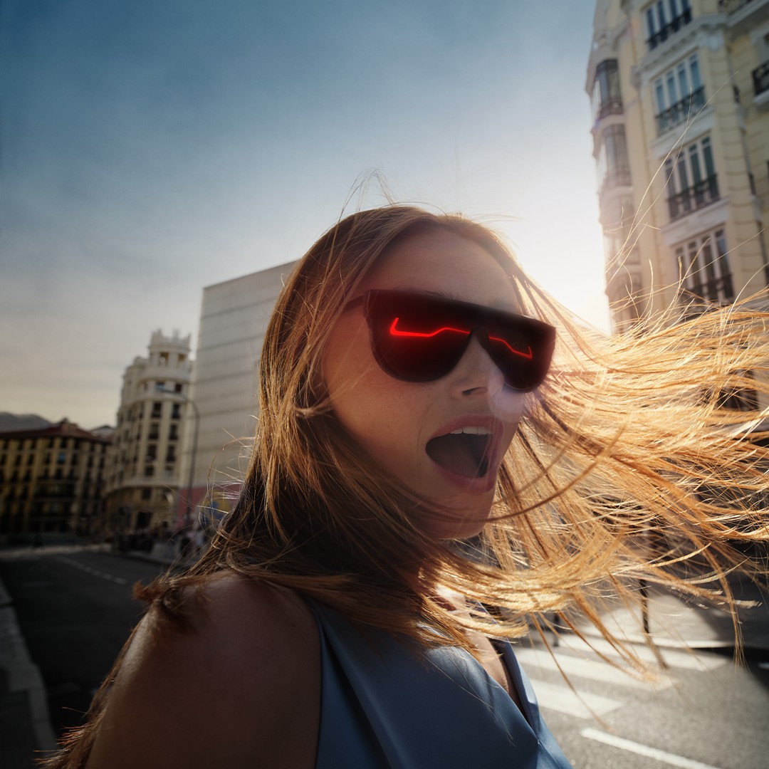 A women with a Lexus reflecting in her sunglasses